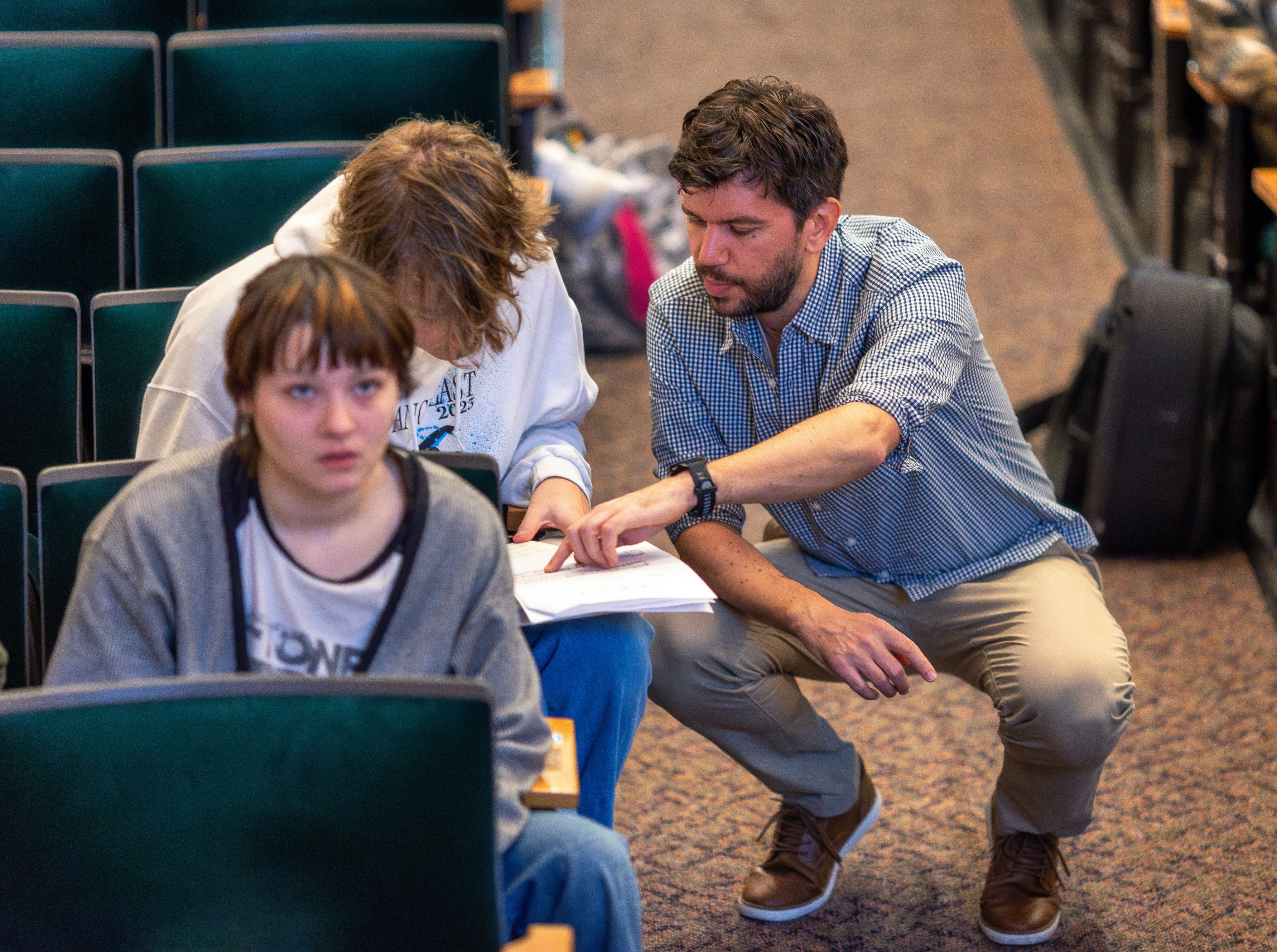 Teacher assisting a student with an assignment