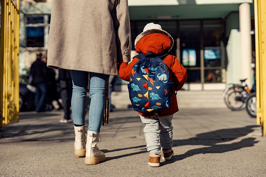 Child walking to school with adult