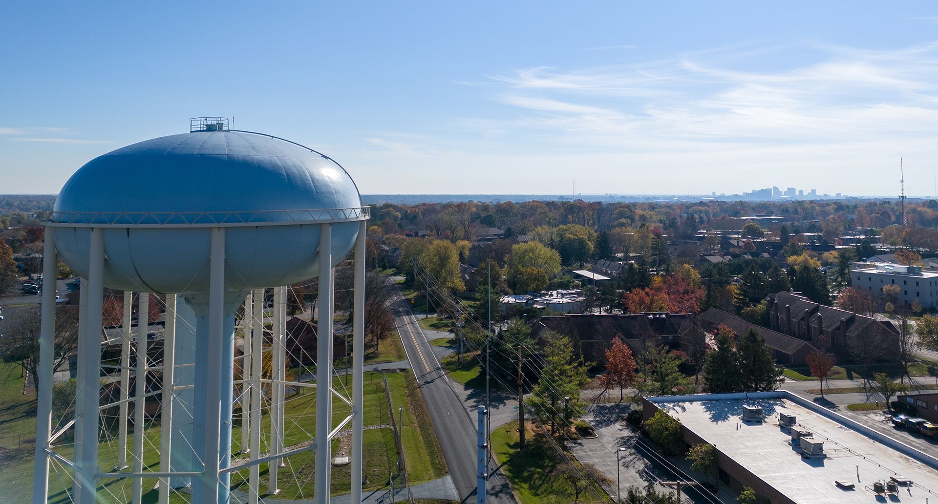 A small town with a large water tower in the foreground
