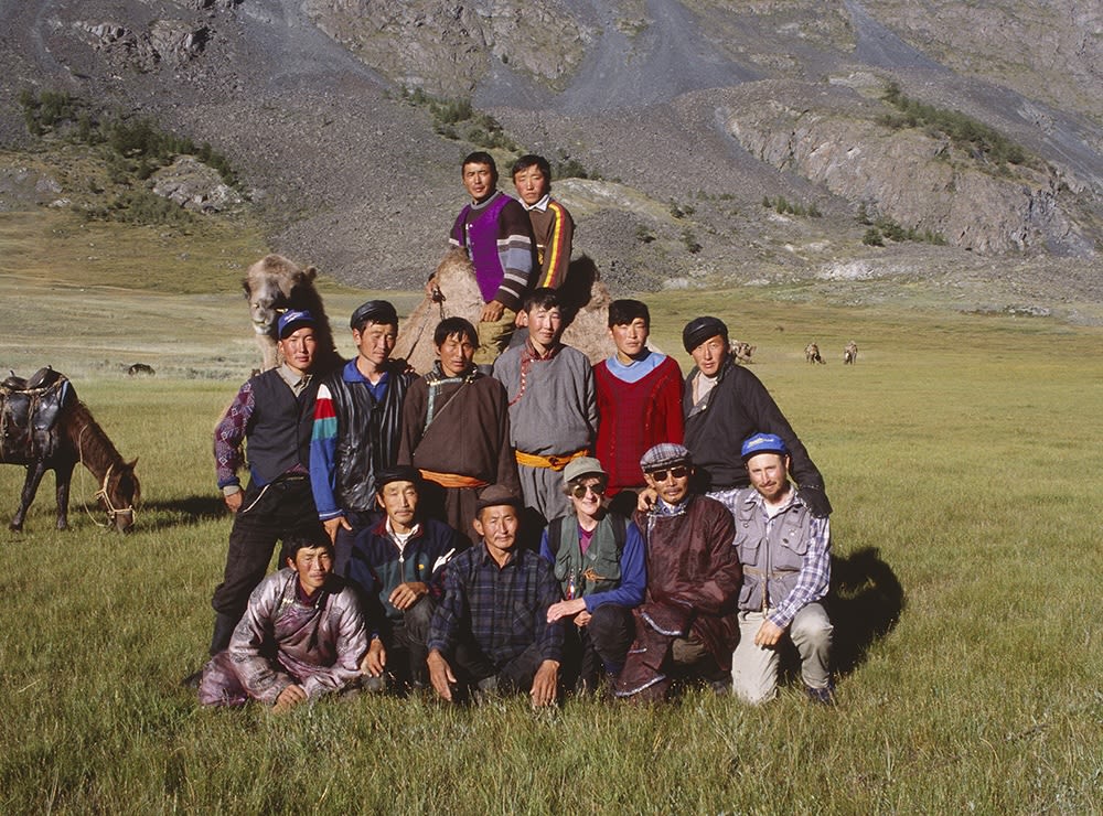 A group of Tuvinian people outdoors in a grassland