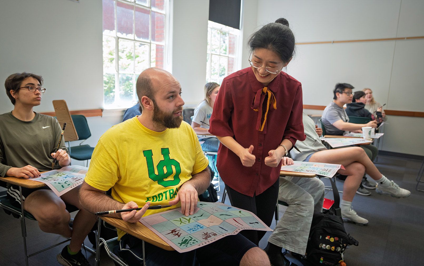 Teacher helping student with an assignment in classroom