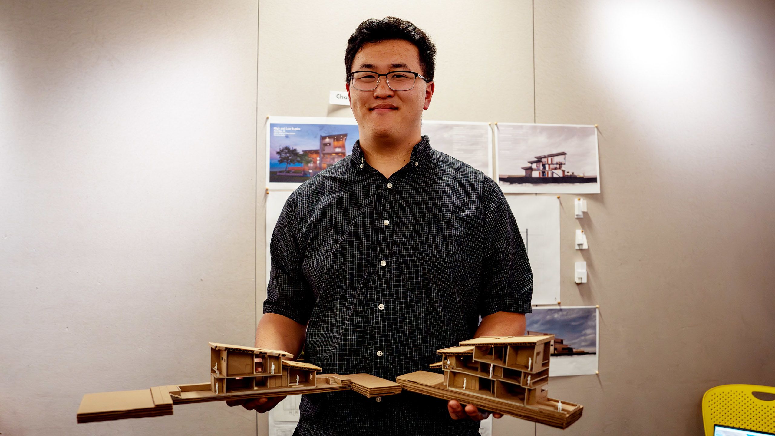 Student holding cardboard architectural design model