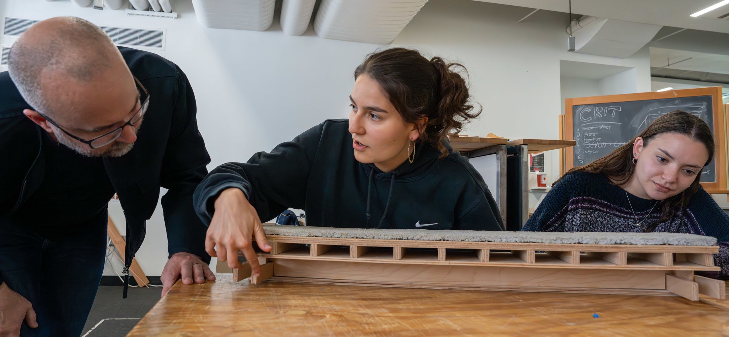 Students showing a model of a building design
