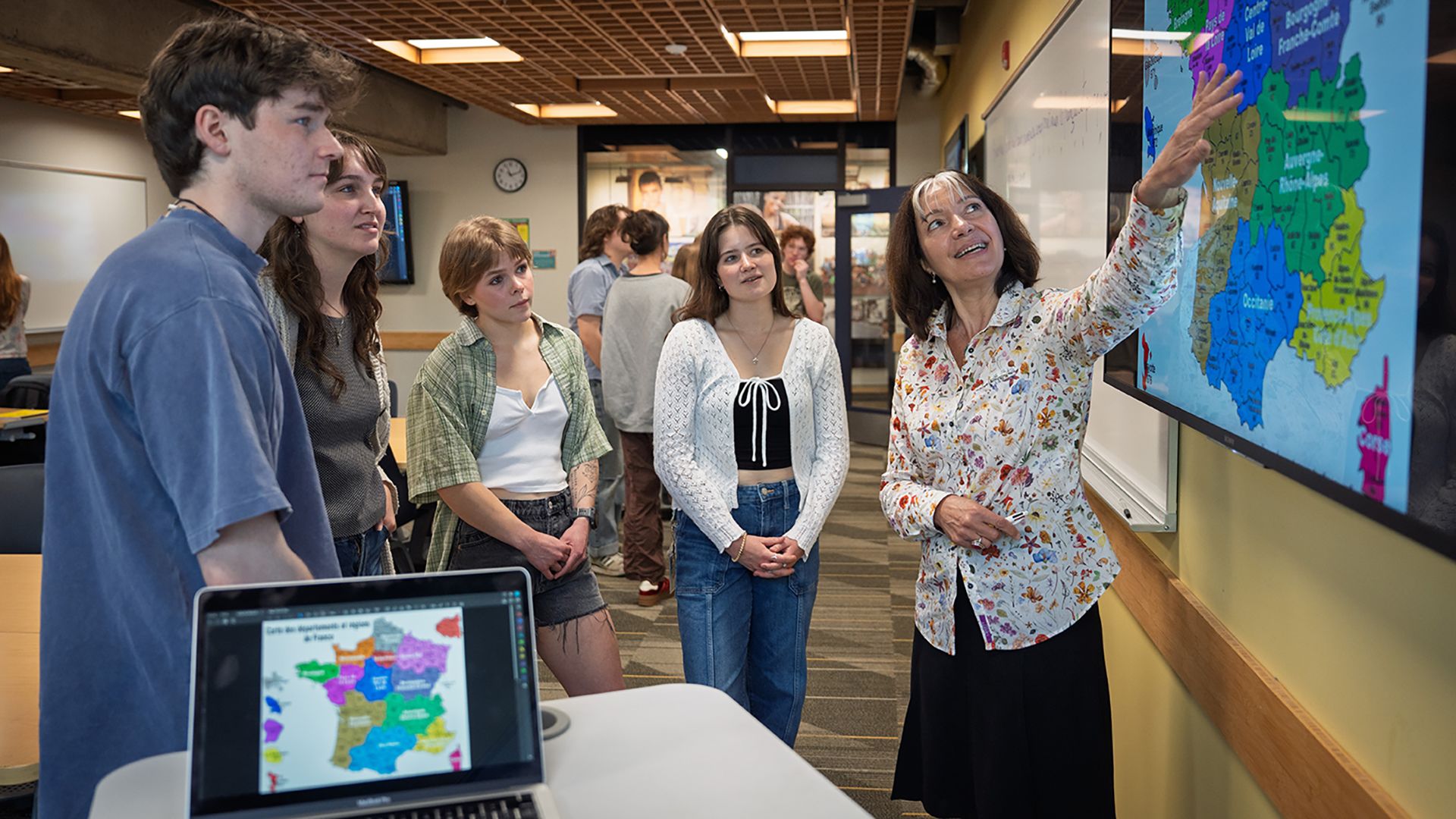 Professor and students looking at a map of France