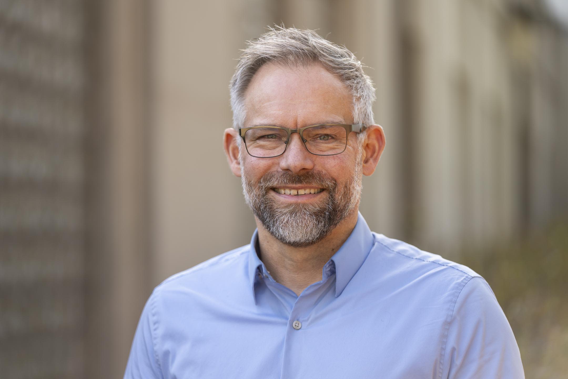 Portrait of a man in a blue collared shirt